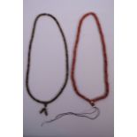 A string of coral beads, together with another string of glass beads, 25" long