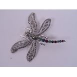 A large silver dragonfly brooch set with marcasite, emerald, sapphire and rubies, with articulated