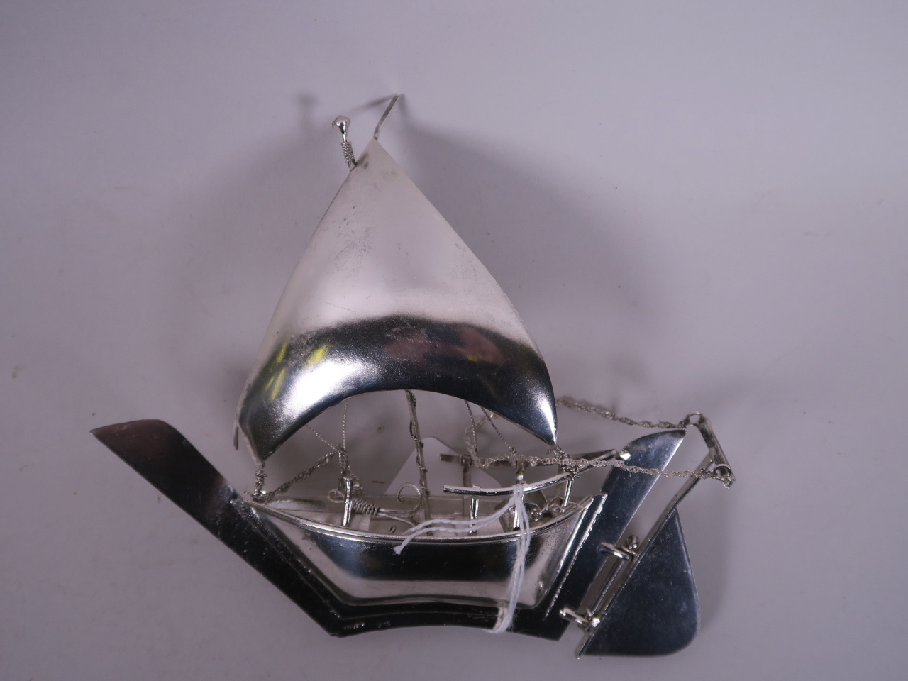 A sterling silver model of a Chinese junk, 6½" long