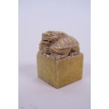 A Chinese soapstone seal with carved decoration of a dragon tortoise to top, 1½" x 1½", 2" high