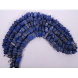 Five strings of heavy cut lapis beads, each 17" long