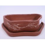 An Oriental red earthenware bonsai pot and stand with engraved floral decoration, 8" wide