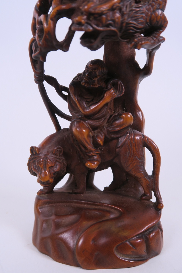 A Chinese carved and pierced hardwood ornament depicting two immortals, 7½" high - Image 3 of 3