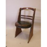 An Arts and Crafts oak side chair, with leather seat and lined finish, stamped to base reg. no.