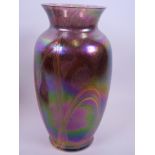 A Loetz style iridescent glass vase with swirled decoration, 9" high