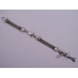 A silver three strand Albert chain, 8" long