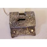 A Middle Eastern steel padlock, with raised gilt and silver coloured Islamic script decoration, with