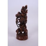 A Chinese carved and pierced hardwood ornament depicting two immortals, 7½" high