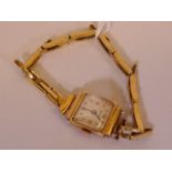 A lady's 18ct gold watch on a 9ct gold expanding strap, watch 8g