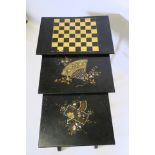 A nest of three Victorian chinoiserie black lacquer occasional tables, the largest decorated with