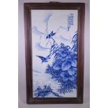 A large Chinese blue and white porcelain panel depicting two birds amongst foliage, seal mark to