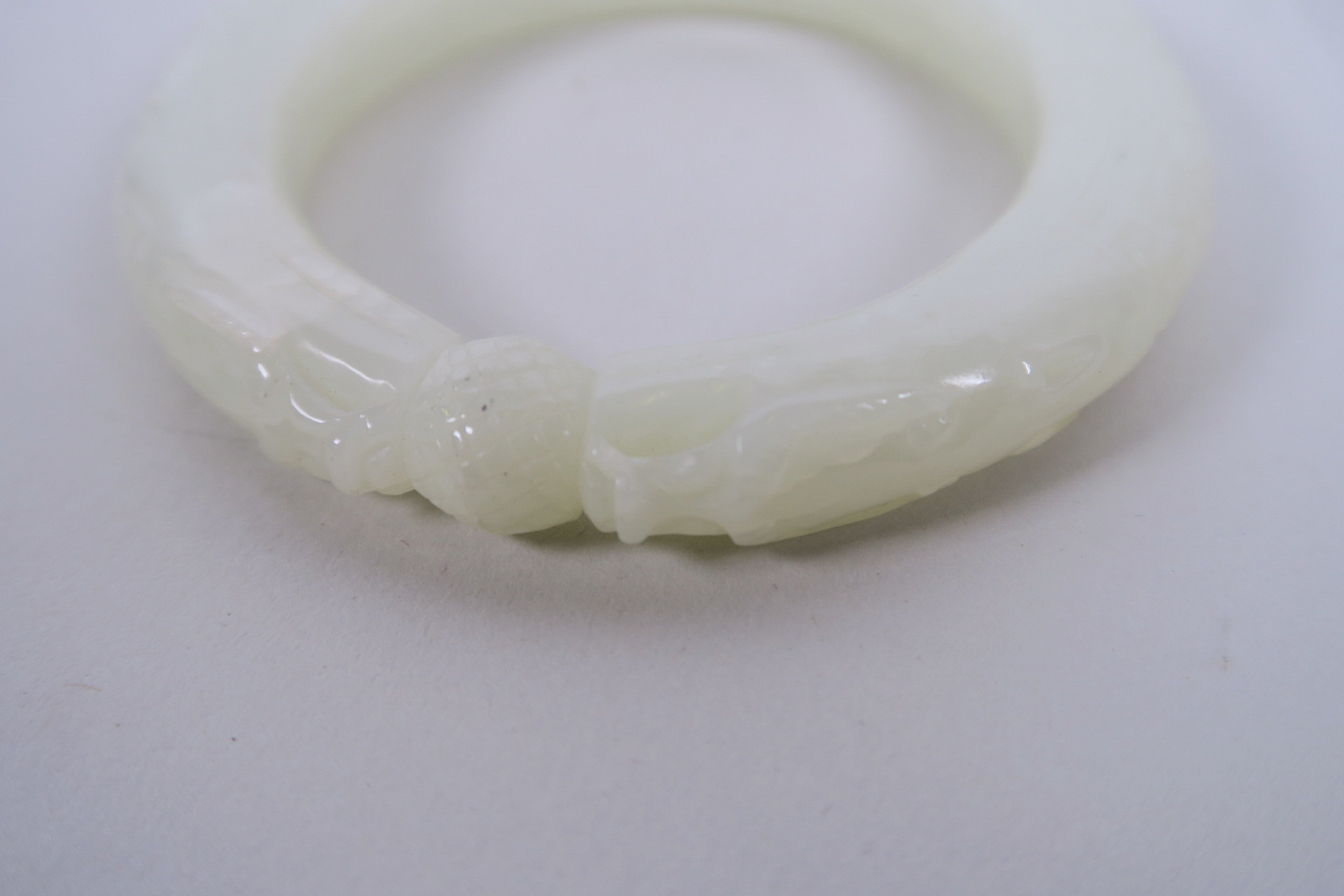 A Chinese carved white jade bangle with dragon head decoration, 3" diameter - Image 2 of 2