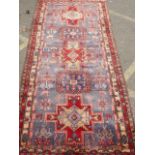A hand woven wool Persian Luri Hamadan carpet, with unique cross design, 125" x 56"