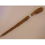 A carved cork walking stick, 34" long