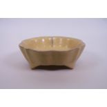 A Chinese crackle glazed pottery footed dish with petal shaped rim, 7½" diameter