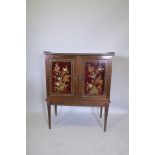 An early C20th French colonial two door cabinet, with lacquered and painted imitation boule work