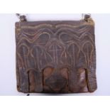 An antique leather Koran case, the front having stitched decoration of Islamic motifs, 11½" x 10"