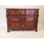 A C18th French oak and fruitwood four drawer commode with shaped front, carved and shaped corners,