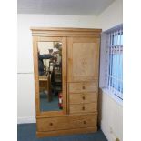 A lined ash Beaconsfield wardrobe, the upper section with mirrored door and cupboard over three