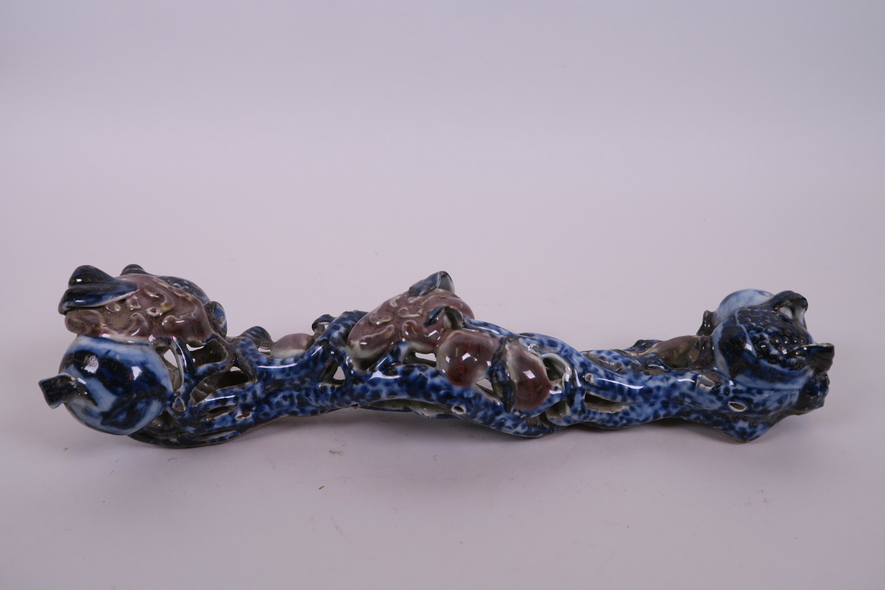 A Chinese blue, white and red porcelain ruyi in the form of a fruiting branch, 12" long