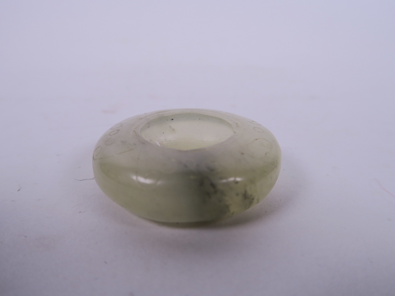 A Chinese carved jade water holder, 2" diameter
