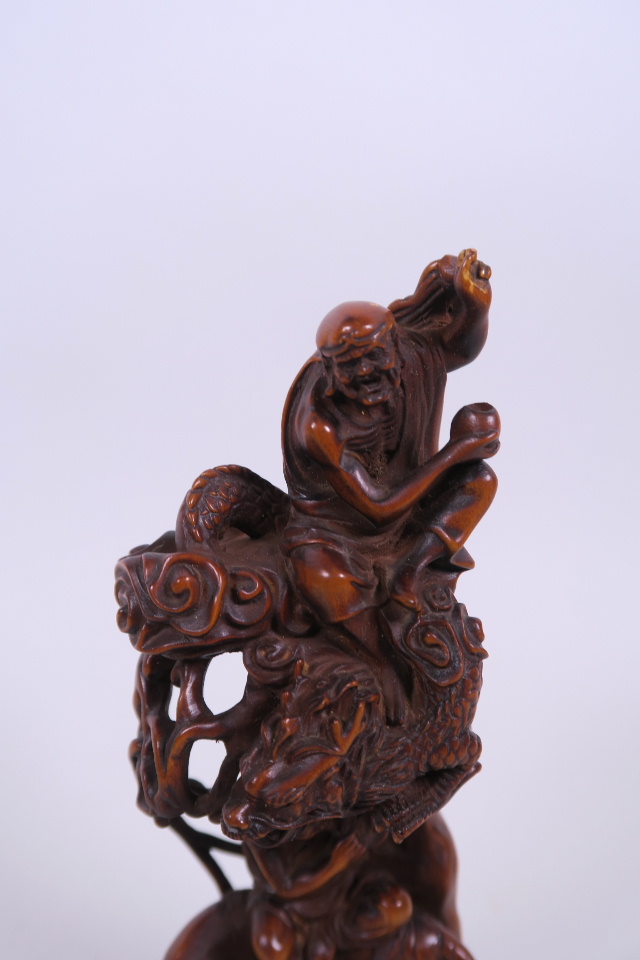 A Chinese carved and pierced hardwood ornament depicting two immortals, 7½" high - Image 2 of 3