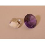 An amethyst cut gem stone, ½" diameter, and another, possibly zirconia