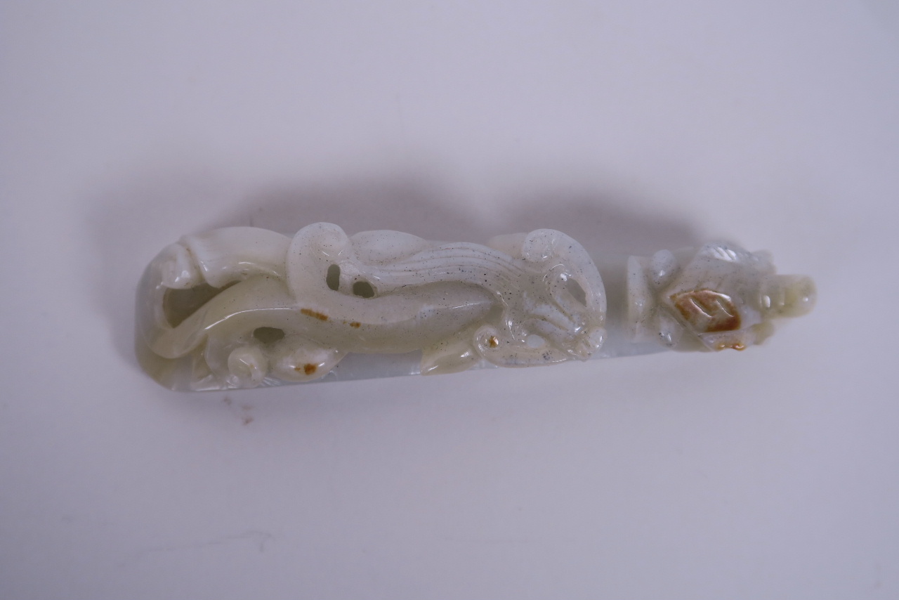 A Chinese celadon jade belt hook carved in the form of a dragon, 4½" long - Image 2 of 2