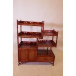 An Oriental hardwood open shelf, with faux bamboo supports and pierced gallery, 31" x 12" x 38"