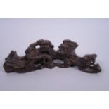 A Chinese carved hardwood brush rest in the form of a tree root, 7½" long