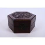 A Chinese hexagonal hardwood box with carved decoration to lid of a dragon and phoenix chasing the