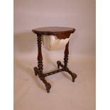 A Victorian burr walnut shaped top work table with pleated silk basket, raised on turned end
