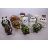 A collection of thirteen money boxes including two ceramic hedgehogs, four owls, two frogs, two