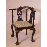 A C19th walnut corner chair with inlaid pierced carved splats, arms and crest, inlaid with an