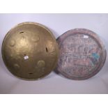 An antique eastern brass shield with engraved decoration, 23" diameter, together with an Egyptian