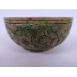 An Islamic soapstone bowl with green highlighted engraved decoration, 4½" diameter (chip to rim)