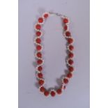 A pearl and red hardstone beaded necklace, 19" long