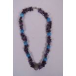 An amethyst beaded necklace, with turquoise and agate feature beads, 23" long