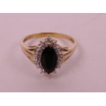 A 14ct gold ring, with marquise cut black gem and diamond cluster, 3.1g