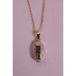 A 9ct yellow gold, emerald and diamond set pendant necklace, on a gold chain, pendant ½"