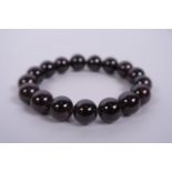 A garnet beaded bracelet, 3" diameter