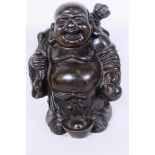 An Oriental bronze figurine of Buddha with a large sack on his back, 9" high