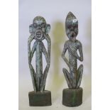 A pair of antique African painted wood figures, 32" high