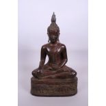 A Thai bronze Buddha seated in meditation with elephant decoration to throne and a copper patina,