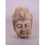 An Oriental carved stone head of Quan Yin, 9½" high