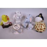 Five ceramic money boxes including two advertising 'B.T. Busby' and 'Ryman's Man', a giraffe,