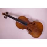 An early C20th violin with a two piece back, lacks bridge and strings, 23½" long