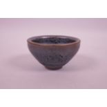 A Chinese Jian ware pottery tea bowl with an iridescent glaze, 3½" diameter