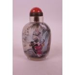 A Chinese reverse painted glass snuff bottle decorated with a sage and acolyte with a buffalo and