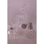 Two cut glass perfume atomisers with chrome plated collars together with a glass figurine of a